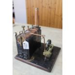 An early 20th Century cast iron hand built stationary steam engine with steam whistle