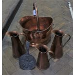 A copper coal bucket together with three copper jugs marked J S & S (Joseph Sankey & Sons) plus a