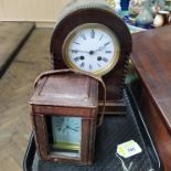 An oak cased chiming mantel clock together with a brass carriage clock in leather carry case with