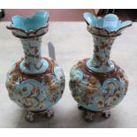 A pair of late 19th/early 20th Century Wilhelm Schiller & Sons Majolica vases decorated with putti,