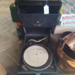 A vintage wind up HMV gramophone with a small selection of 45 singles