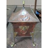 An Arts and Crafts copper and brass coal bin on legs (bin with liner),