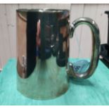 A silver pint tankard of plain form, hallmarked Birmingham 1925 (some dents noted),