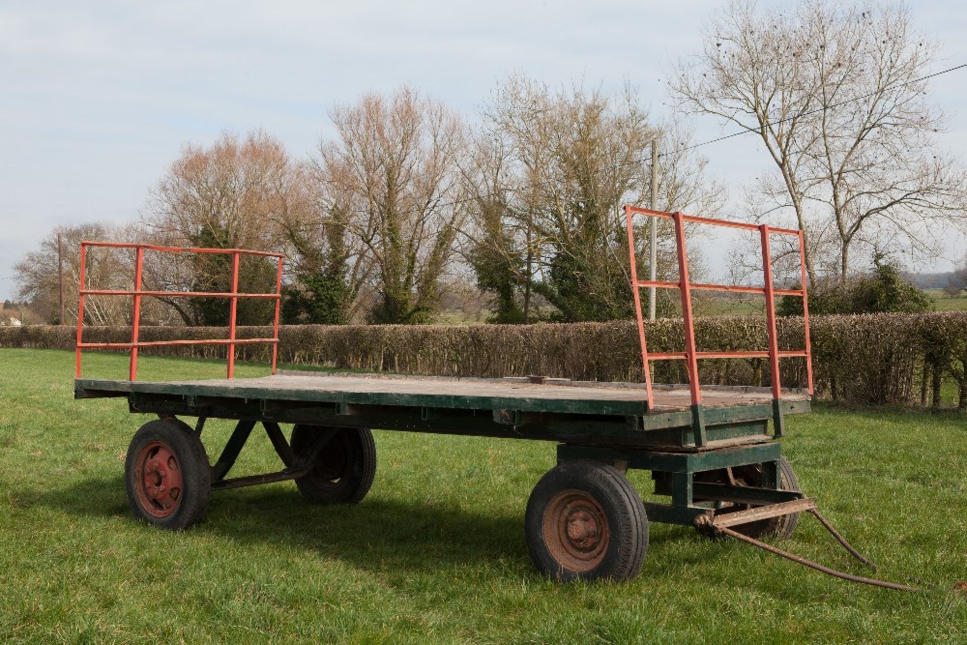 Four wheeled flat hay trailer, age unknown. Deck 16'6" long 6'10" wide.