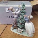 A large boxed Lladro figure group 'Trimming the Tree' 05897 (missing the star from the top of the