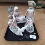 Three Lladro children figurines, a seated girl with flowers,