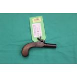 A percussion pocket pistol with slab sided one piece grip, turn off barrel and concealed trigger,