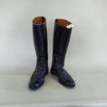 A pair of black leather riding boots (size 10),