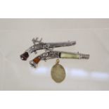 Two white metal brooches with embellishments in the form of Flintlock pistols with a 1887 dated