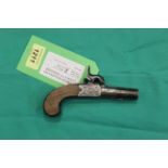 A percussion pocket pistol with slab sided one piece grip, turn off barrel and concealed trigger,