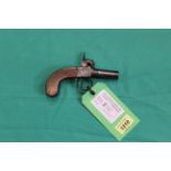 A percussion pocket pistol with slab sided one piece grip,
