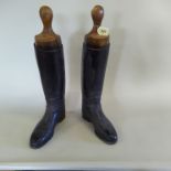 A pair of black leather riding boots complete with vintage wooden lasts (boots approx size 10/11)