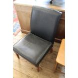 A black vinyl upholstered chair