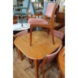 Four mid Century teak style dining chairs with dusky pink upholstery and a dining table