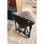 An early 19th Century oak gate leg corner table of Flemish design