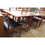 A mid Century Bendt Winge style folding dining table together with six black vinyl seat dining