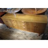 A mid Century Australian walnut sideboard comprising three drawers between two double door