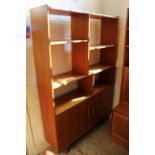 A mid Century free standing shelving unit with two cupboards on splay square legs