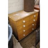 A mid Victorian grained pine five drawer chest with porcelain knobs