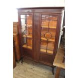 An Edwardian inlaid mahogany two door glazed display cabinet