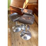 Four Italian chrome and brown leatherette swivelling adjustable bar stools