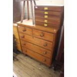 A late Victorian satinwood five drawer chest with turned mahogany knobs