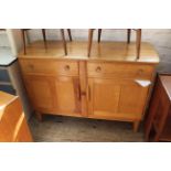 An Ercol light oak sideboard with two drawer and cupboards