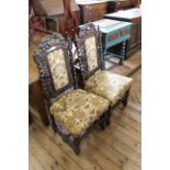 Two carved oak upholstered dining chairs