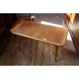 A vintage blonde teak coffee table