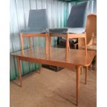 A teak Archie Shine for Robert Heritage extending dining table with extra leaf and two original