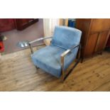 An angular vintage chrome and blue suedette upholstered armchair