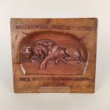 A carved walnut wall plaque featuring a slain 'British' lion with Latin inscriptions