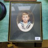 An Edwardian oval watercolour portrait of a boy in Naval dress,