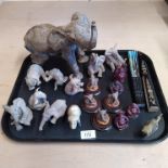 A collection of fourteen composition elephants,