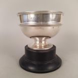 A silver bowl with pedestal base on wooden stand, hallmarked Birmingham 1938,