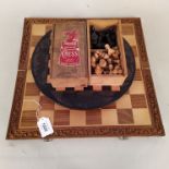 A carved wooden in African style round chess board, a wooden example,
