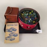 A large tin of marbles,