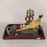 A brass dolphin doorstop, a painted cast iron pheasant doorstop,