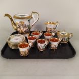 A Capodimonte fifteen piece tea set with embossed flowers and figures with gilded decoration