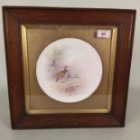 An oak framed Royal Doulton dish hand painted with partridges,