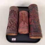 Three carved bamboo brush holders depicting seated scribes and animals in a bamboo forest plus a