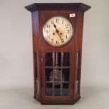 A 1950's mahogany cased wall clock with eight day striking movement,