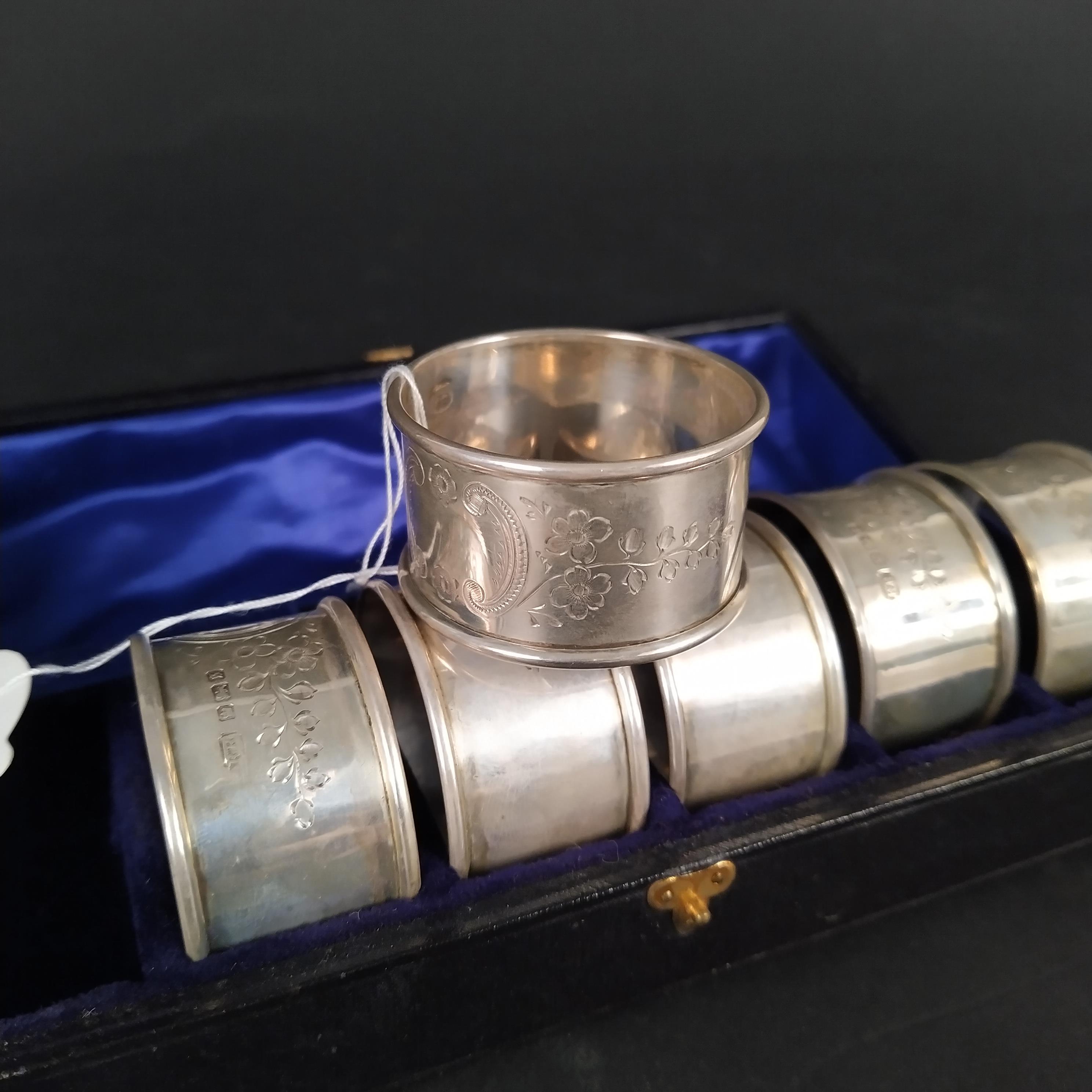 A cased set of six silver napkin rings with engraved foliate decoration, - Image 2 of 3