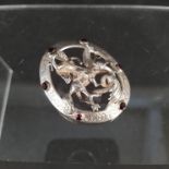 A large silver brooch depicting George and the Dragon set with garnets