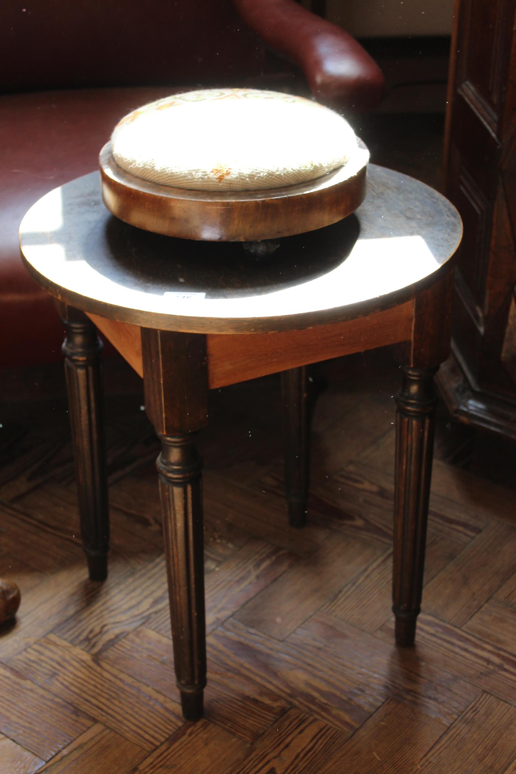 An early 20th Century table plus a Victorian embroidered pad stool