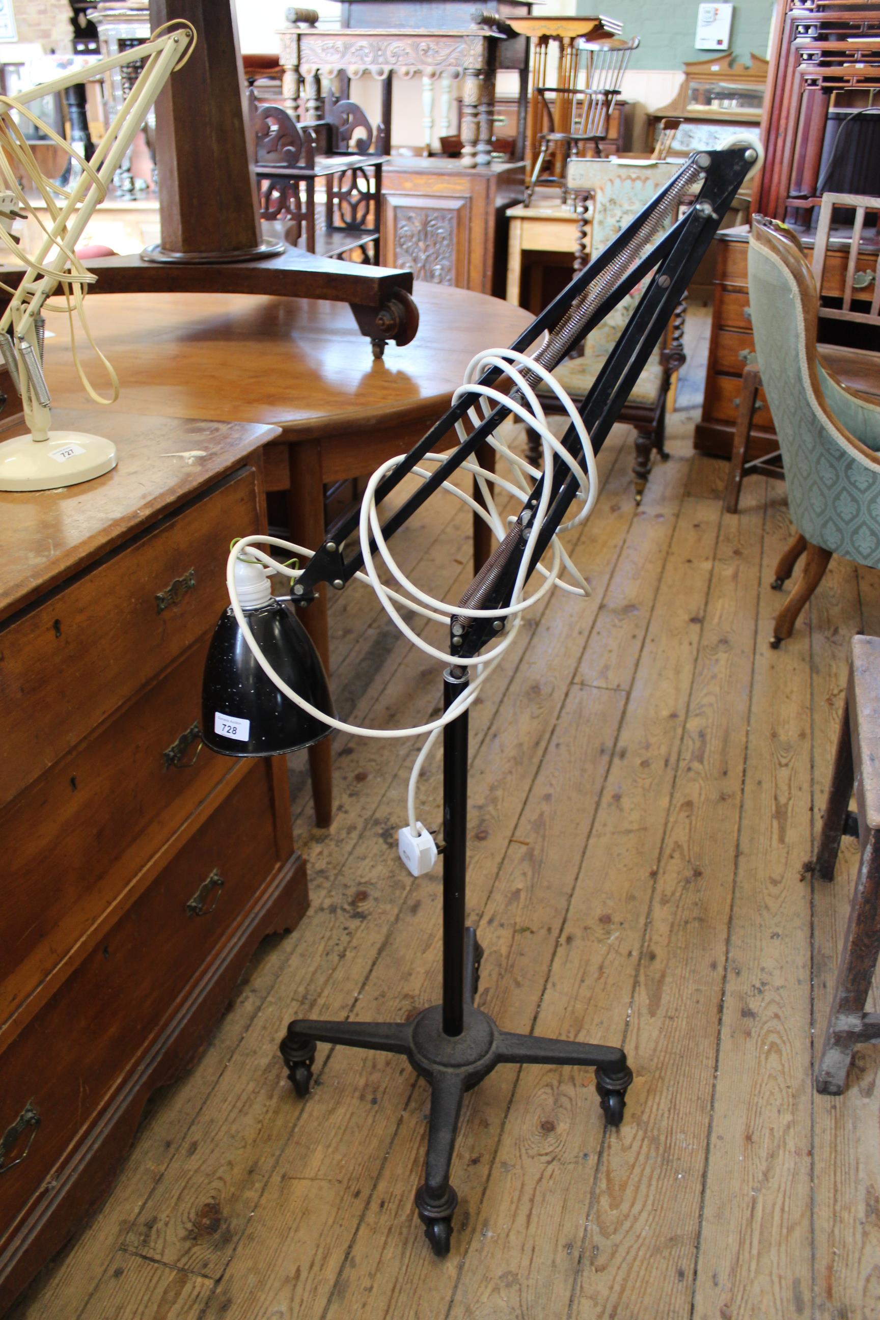 A vintage lamp by Anglepoise with cast iron base standing on castors