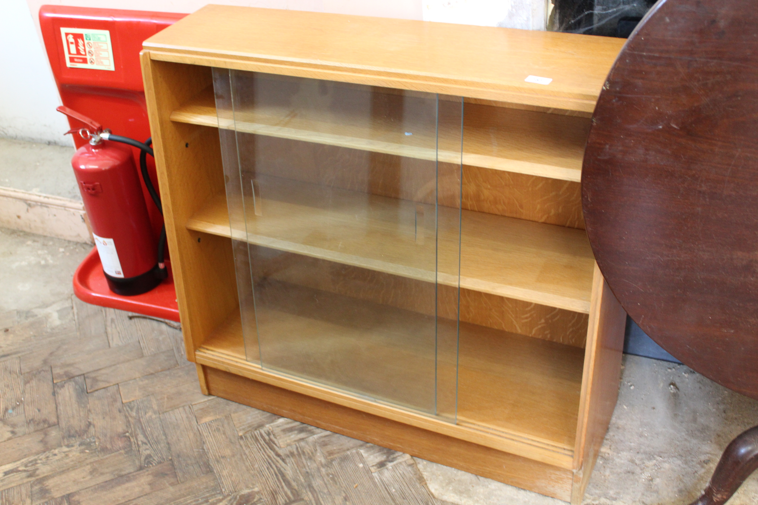 A mid Century design teak sloping glass fronted bookcase