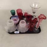 A small collection of glassware including cranberry wine glasses,