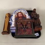 An antique carved wooden religious group, a large porcelain plaque of Jesus,