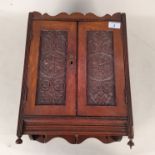 An Edwardian oak cased smokers wall cabinet with contents including two cased Meerschaum pipes
